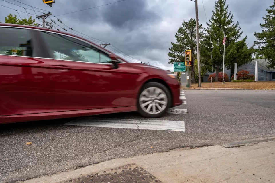 Red car turning right on red light.